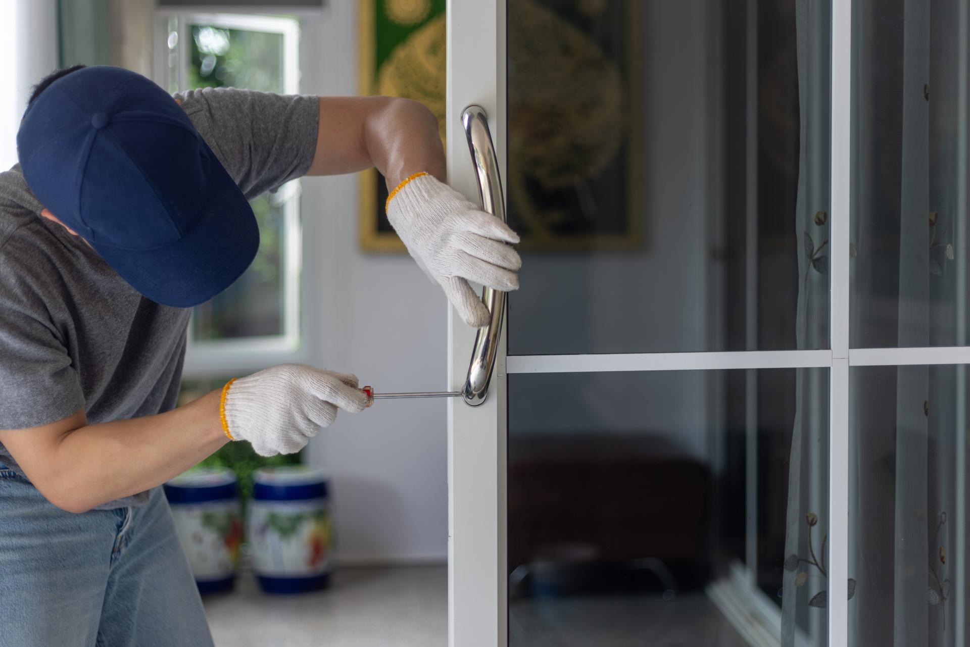 Person using screwdriver on window